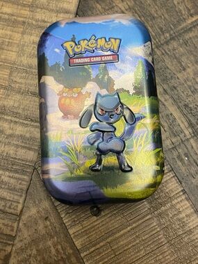 Pokémon TCG:metal tin featuring Riolu-listing for 1 tin and sticker